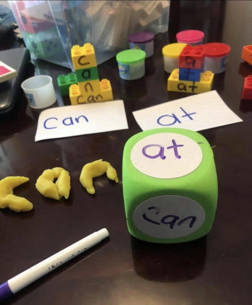 Hands-on preschool literacy activity in Havana, Florida — sight words 'can' and 'at' explored with blocks, playdough, and word dice at Teresa Delores Educational & Developmental Center