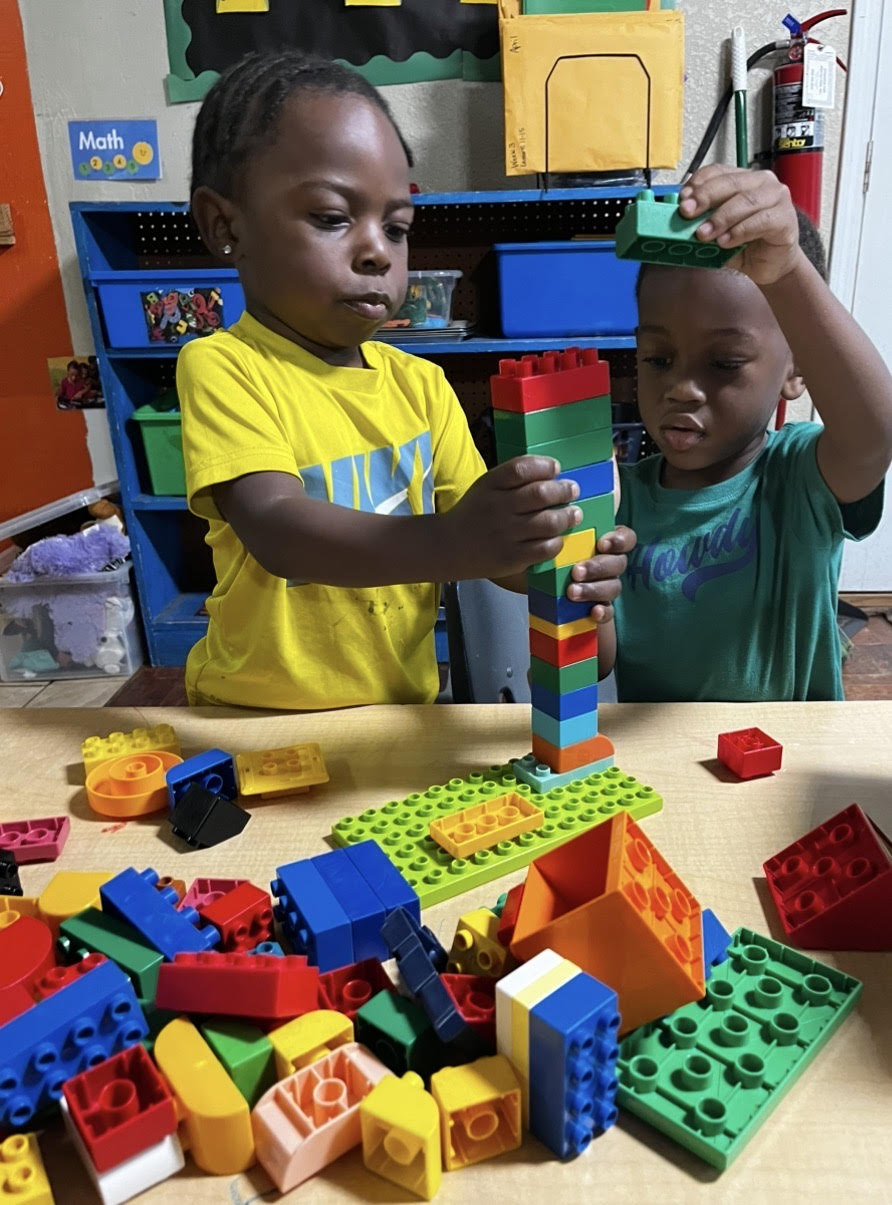 Two children building with colorful blocks at Teresa Delores Educational & Developmental Center in Havana, Florida